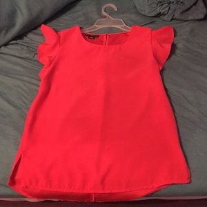 Pinky-Coral blouse with butterfly sleeve detail.